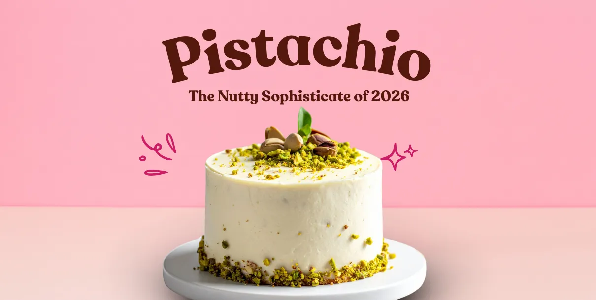 Pistachio‑Themed Cake Layered With Pale Green Frosting And Topped With Crushed Pistachios On A Simple Dessert Stand.